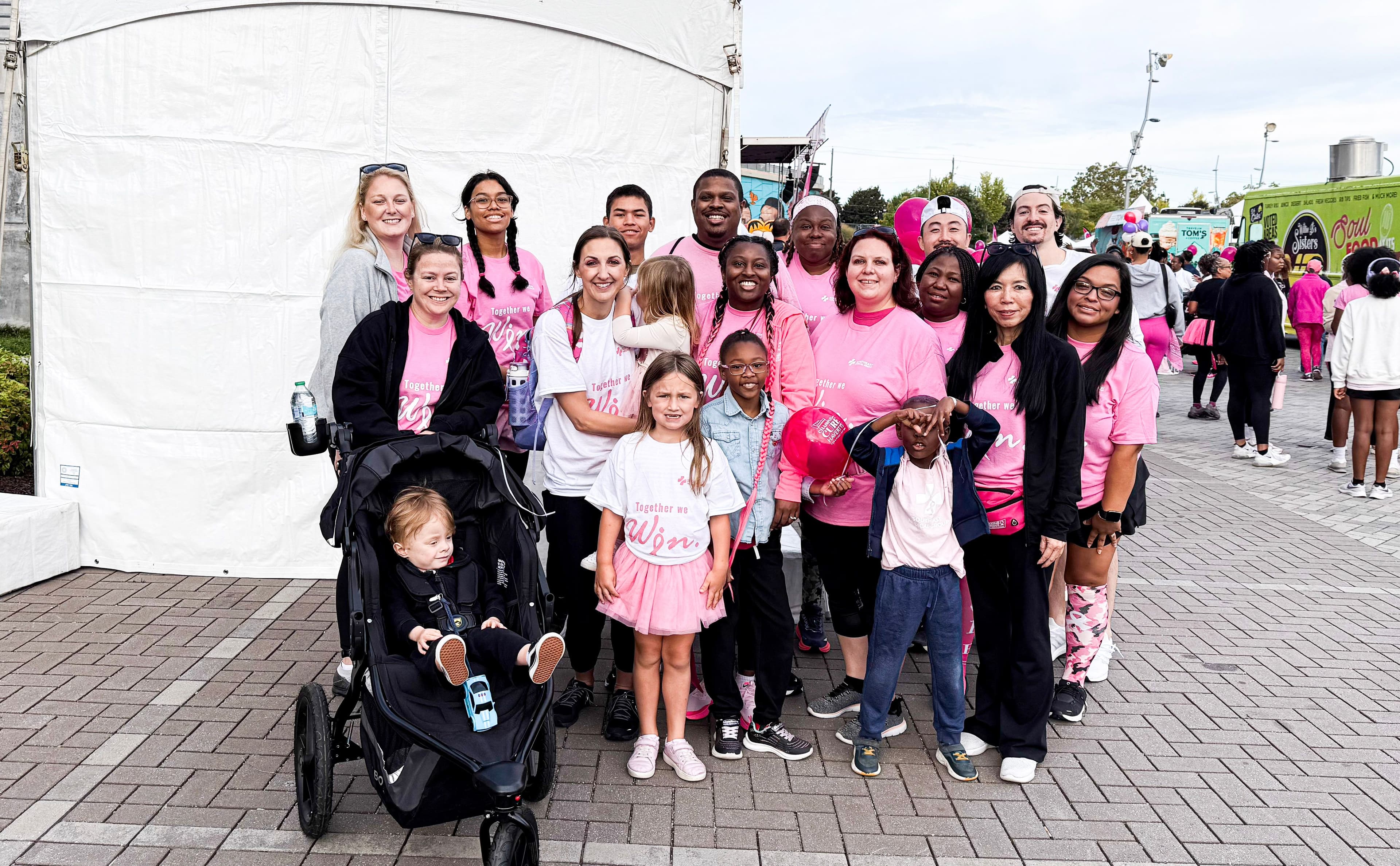 Breast Cancer Awareness: Group of smiling women wearing shirts with pink breast cancer awareness ribbons.